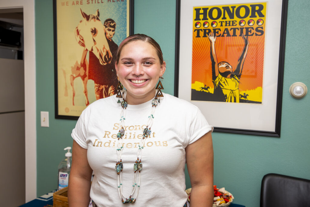 Undergraduate student at the University of Illinois Urbana-Champaign wearing a t-shirt that reads Strong Resilient Indigenous.